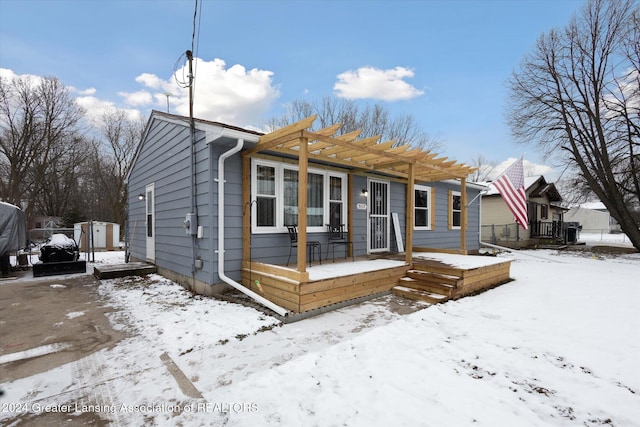 bungalow-style house with a pergola and a wooden deck