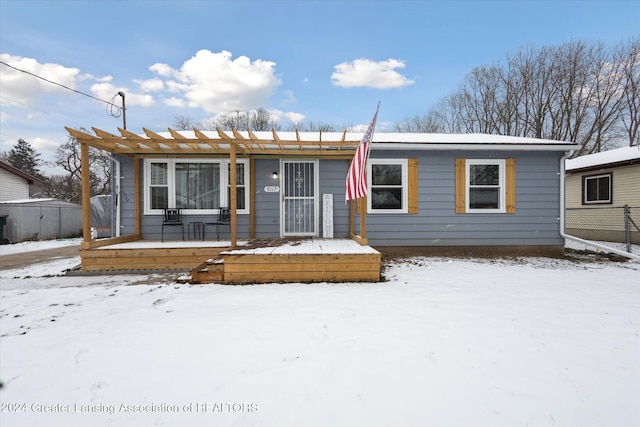 view of front of property with a deck and a pergola