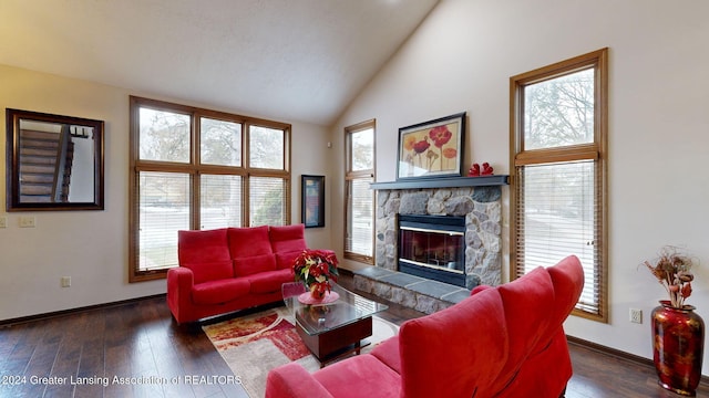 living room with plenty of natural light, dark hardwood / wood-style floors, and vaulted ceiling