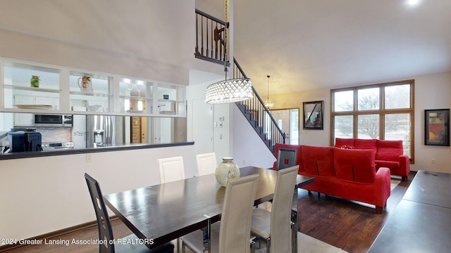 dining room with hardwood / wood-style floors and a notable chandelier