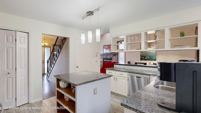 kitchen featuring a center island, dishwasher, pendant lighting, light hardwood / wood-style floors, and white cabinets