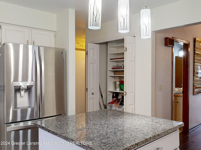 kitchen with dark hardwood / wood-style floors, decorative light fixtures, white cabinetry, dark stone countertops, and stainless steel refrigerator with ice dispenser