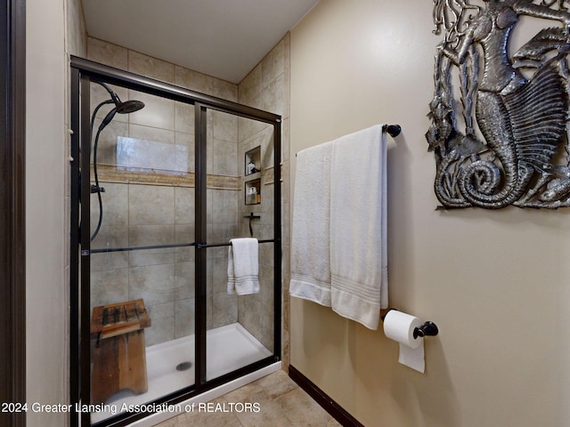 bathroom with a shower with shower door