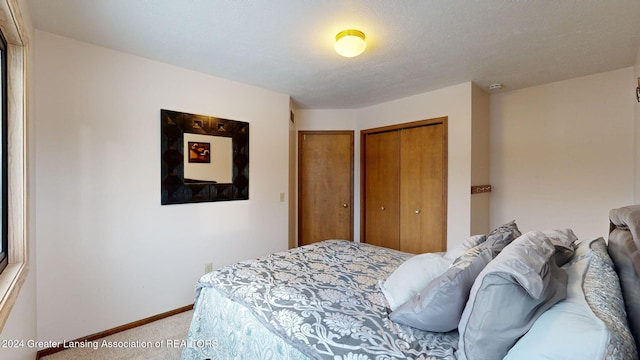 bedroom featuring a textured ceiling and carpet