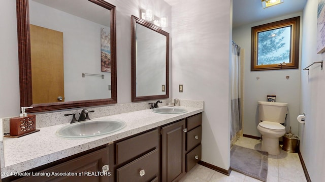 bathroom with vanity, toilet, tile patterned flooring, and a shower with shower curtain