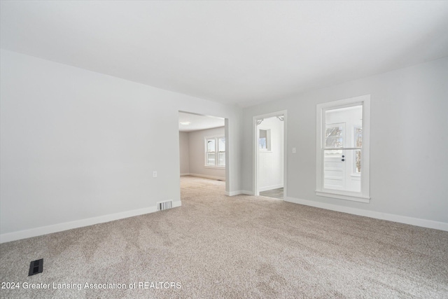 unfurnished room featuring carpet