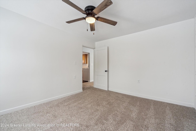 empty room with ceiling fan and carpet