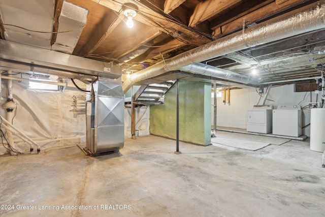 basement featuring washer and dryer and heating unit