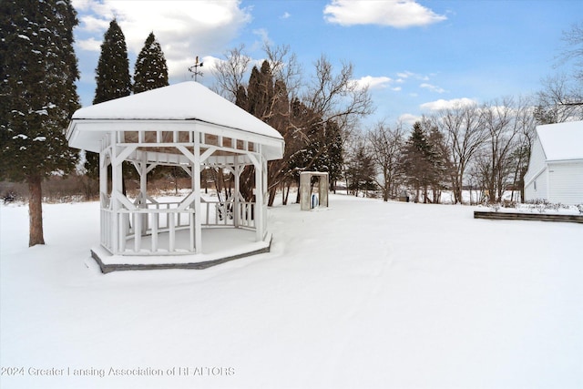 yard covered in snow with a gazebo