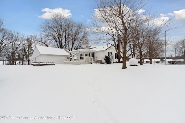 yard layered in snow with a porch