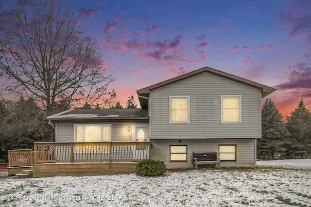 view of snow covered back of property