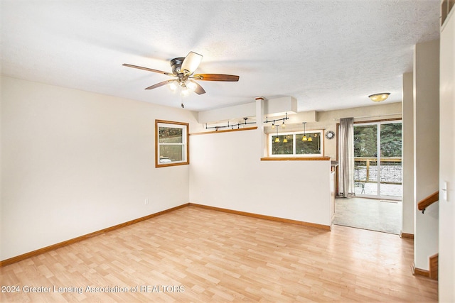 spare room with ceiling fan, a textured ceiling, and hardwood / wood-style flooring