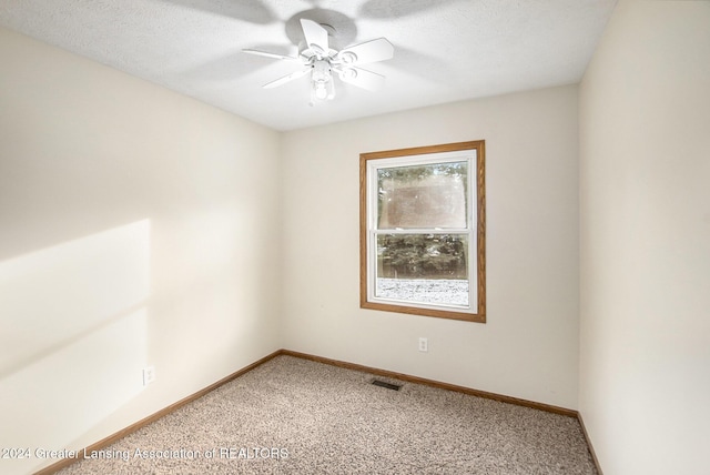 spare room featuring ceiling fan and carpet floors