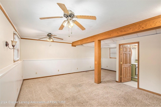 basement featuring ceiling fan and light colored carpet