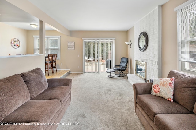 living room featuring a fireplace and light colored carpet