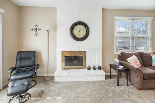 carpeted living room with a brick fireplace