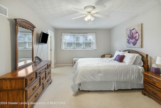 bedroom with light carpet and ceiling fan