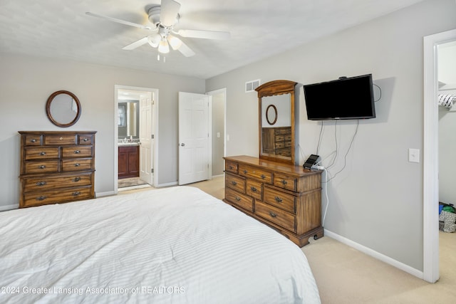 carpeted bedroom featuring connected bathroom and ceiling fan