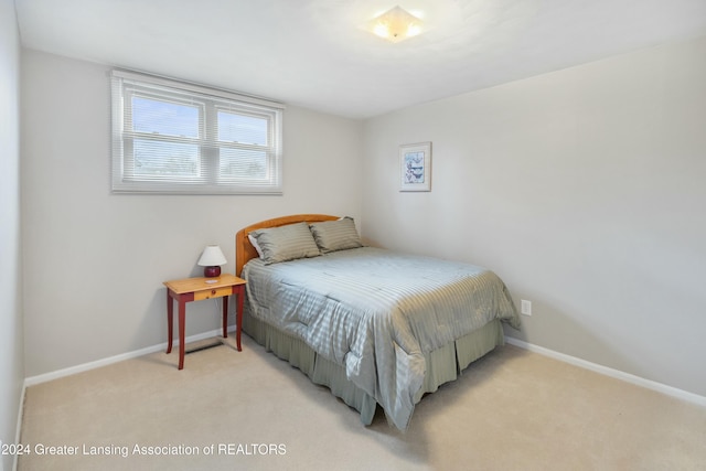 bedroom featuring light carpet