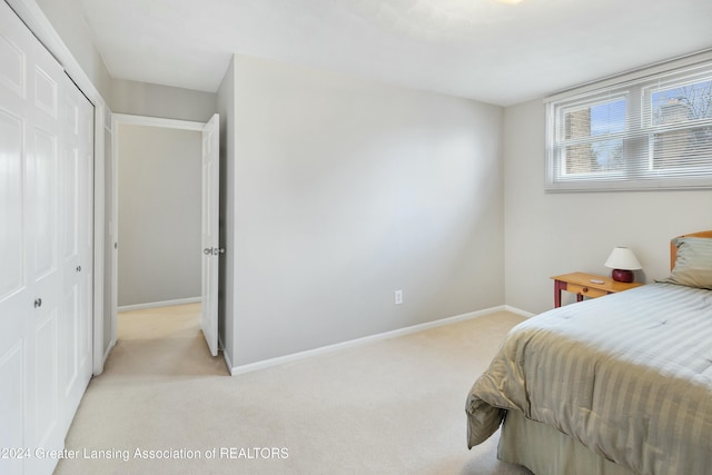 carpeted bedroom featuring a closet