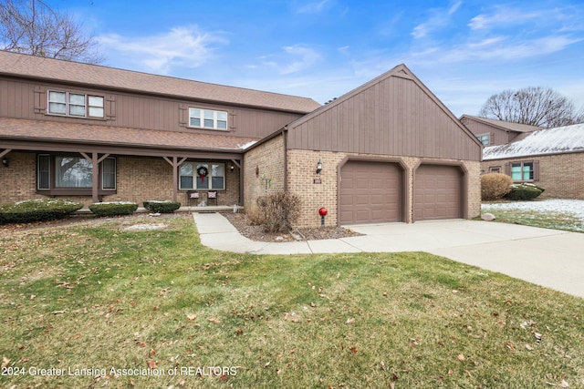 view of front of house with a front yard and a garage