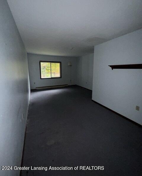 unfurnished room featuring a baseboard radiator