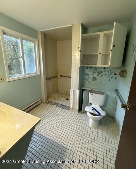 bathroom with walk in shower, tile patterned flooring, a baseboard heating unit, toilet, and vanity