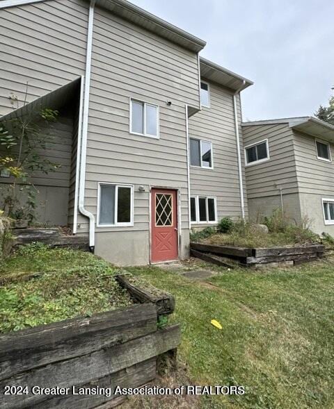 rear view of house with a yard