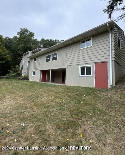 rear view of house with a lawn