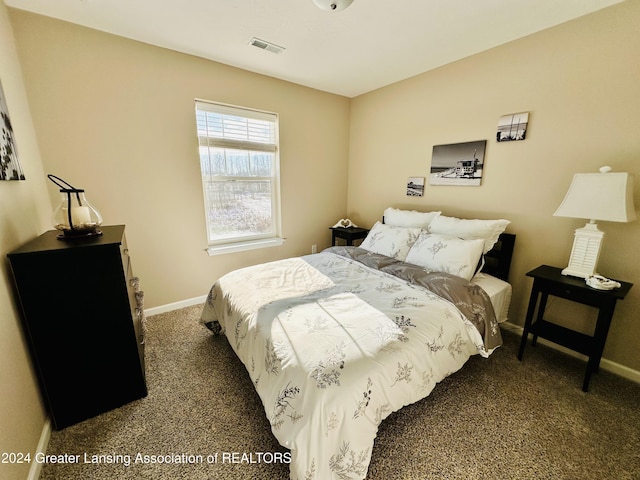 bedroom with dark colored carpet