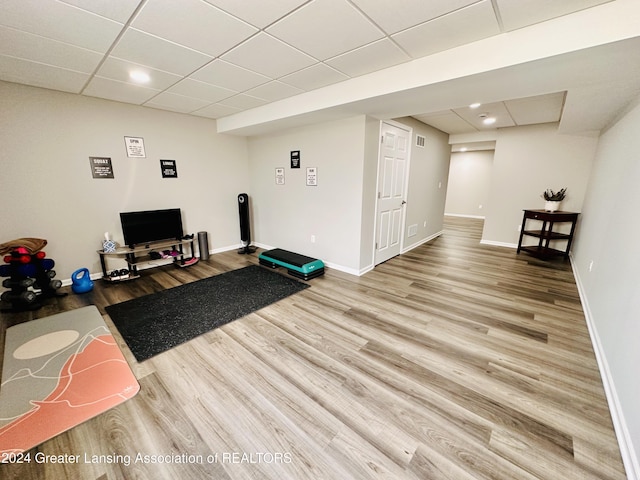 exercise area featuring hardwood / wood-style flooring and a paneled ceiling