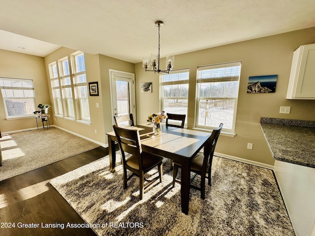 dining room featuring an inviting chandelier and dark hardwood / wood-style flooring