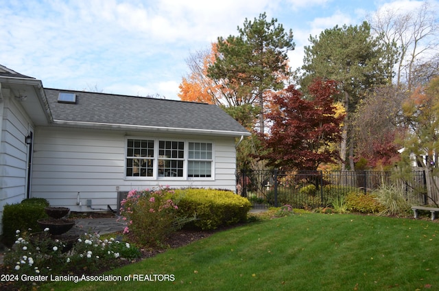 view of side of property featuring a yard