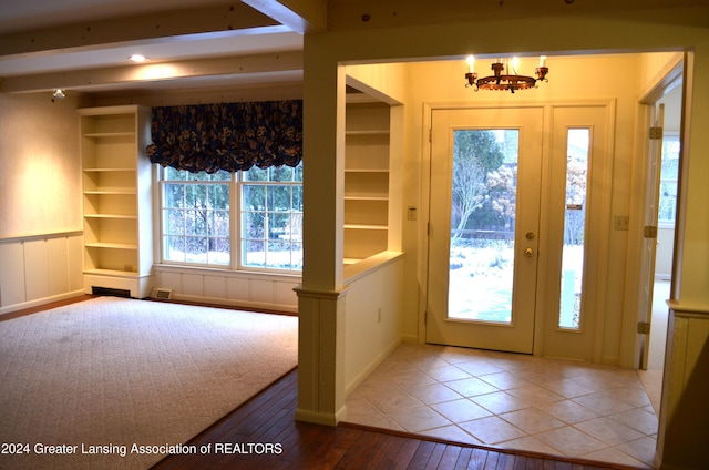 foyer entrance featuring an inviting chandelier and hardwood / wood-style floors