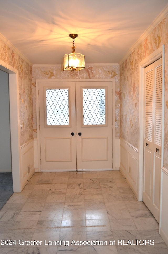 entryway with french doors and ornamental molding