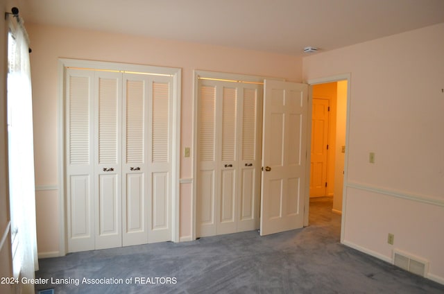 unfurnished bedroom featuring dark colored carpet