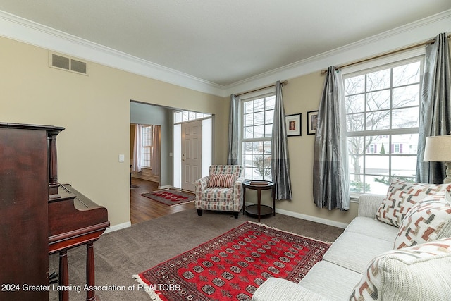 carpeted living room with ornamental molding