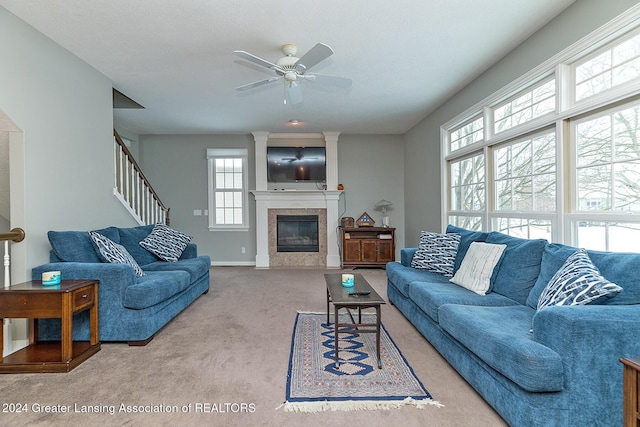 living room with ceiling fan, a fireplace, and carpet flooring