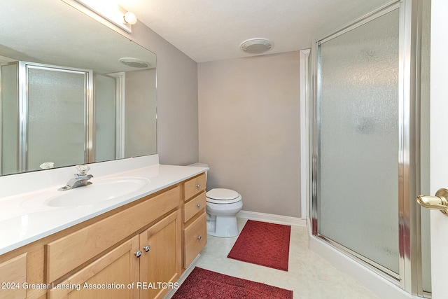 bathroom featuring toilet, walk in shower, and vanity