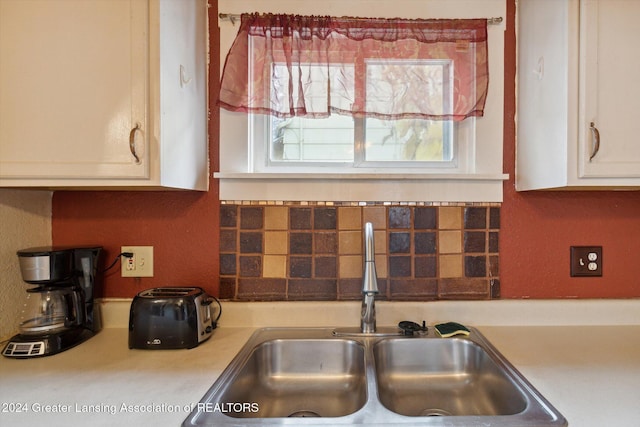 kitchen with white cabinetry and sink