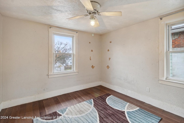 spare room with hardwood / wood-style floors, a textured ceiling, and ceiling fan