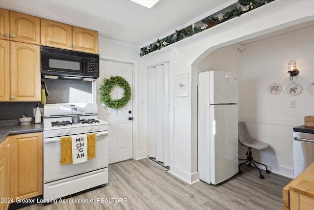 kitchen with light hardwood / wood-style floors, white appliances, and backsplash