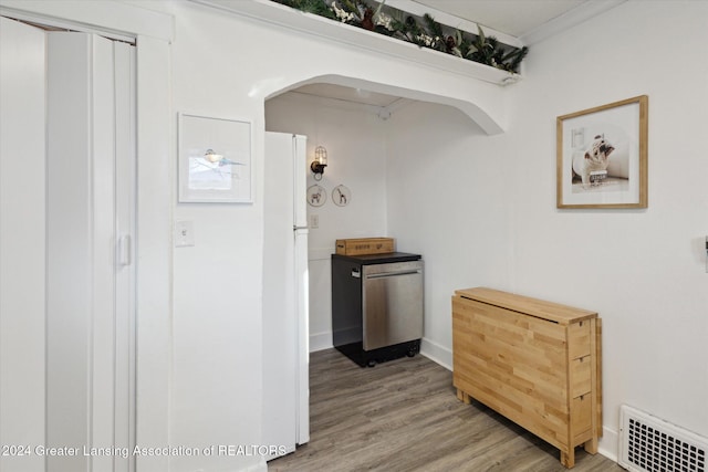 kitchen featuring crown molding, white fridge, and wood-type flooring