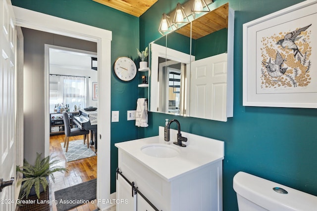 bathroom featuring hardwood / wood-style floors, vanity, and toilet