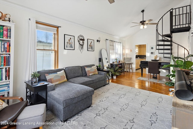 living room featuring ornamental molding, light hardwood / wood-style flooring, ceiling fan, and lofted ceiling