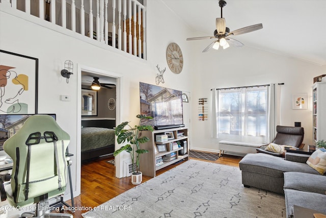 living room featuring ceiling fan, dark wood-type flooring, and high vaulted ceiling