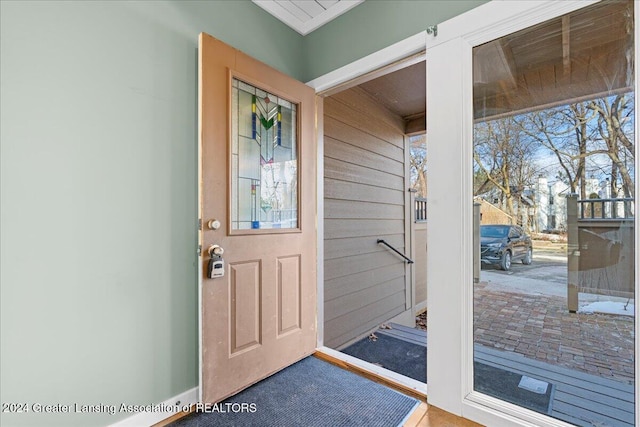 doorway featuring wood walls