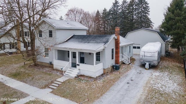 bungalow-style house featuring an outdoor structure, a garage, and central air condition unit