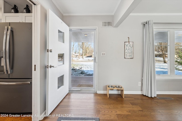 entryway featuring crown molding and dark hardwood / wood-style floors