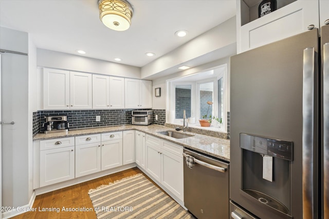 kitchen featuring white cabinetry, sink, and appliances with stainless steel finishes